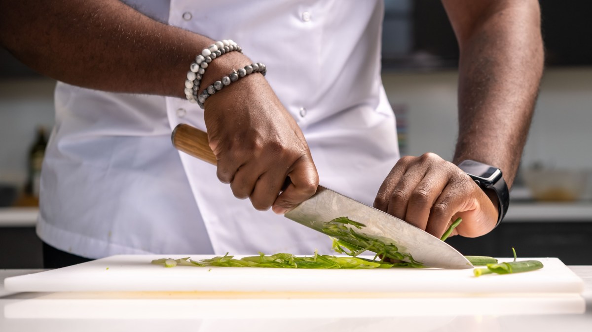 Knife Skills Image 1 a person cutting food on a table