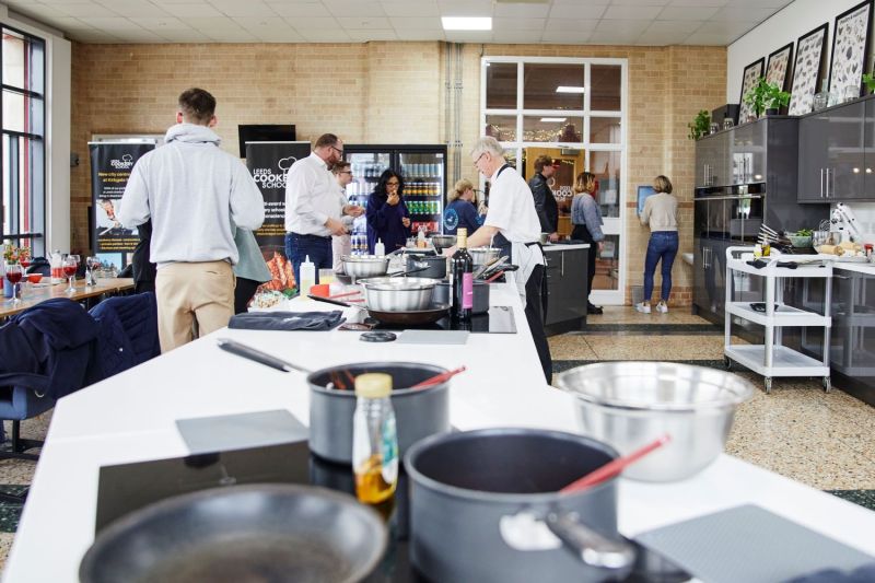 291A7447 a group of people preparing food in a kitchen