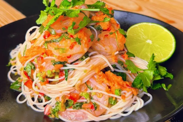 a plate of food sitting on top of a wooden table