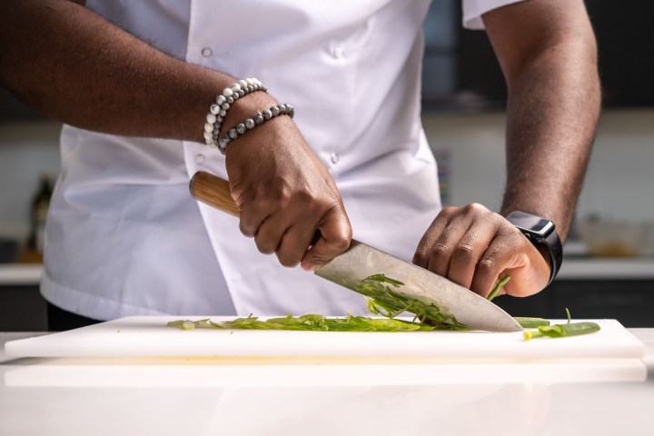 a person cutting food on a table