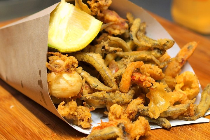 a plate of food sitting on top of a wooden table