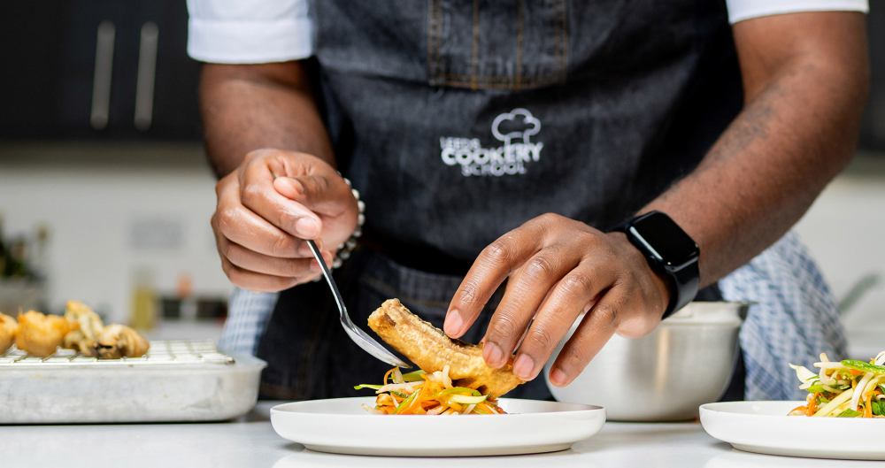 a man cutting food on a plate